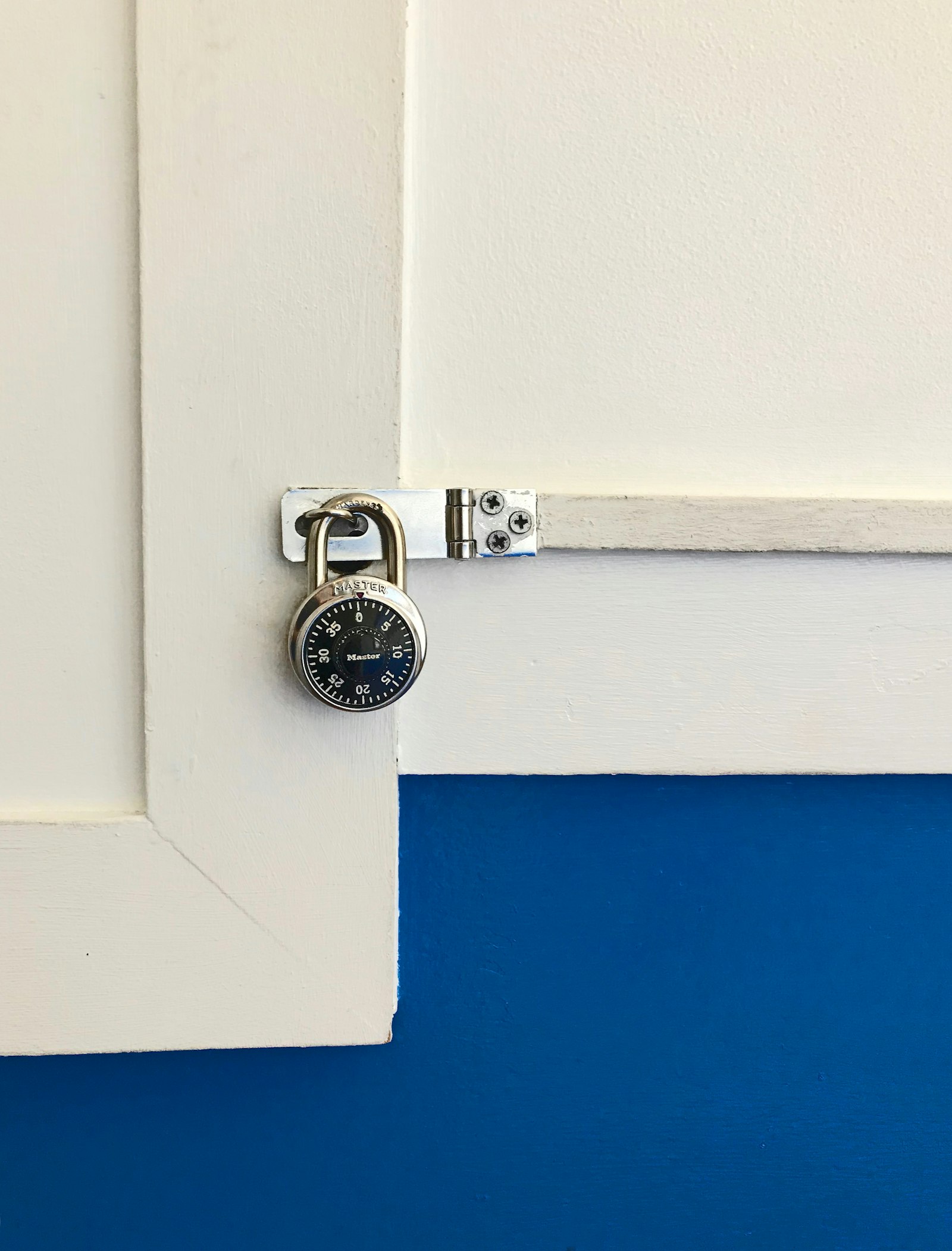 Combination padlock securing a cabinet